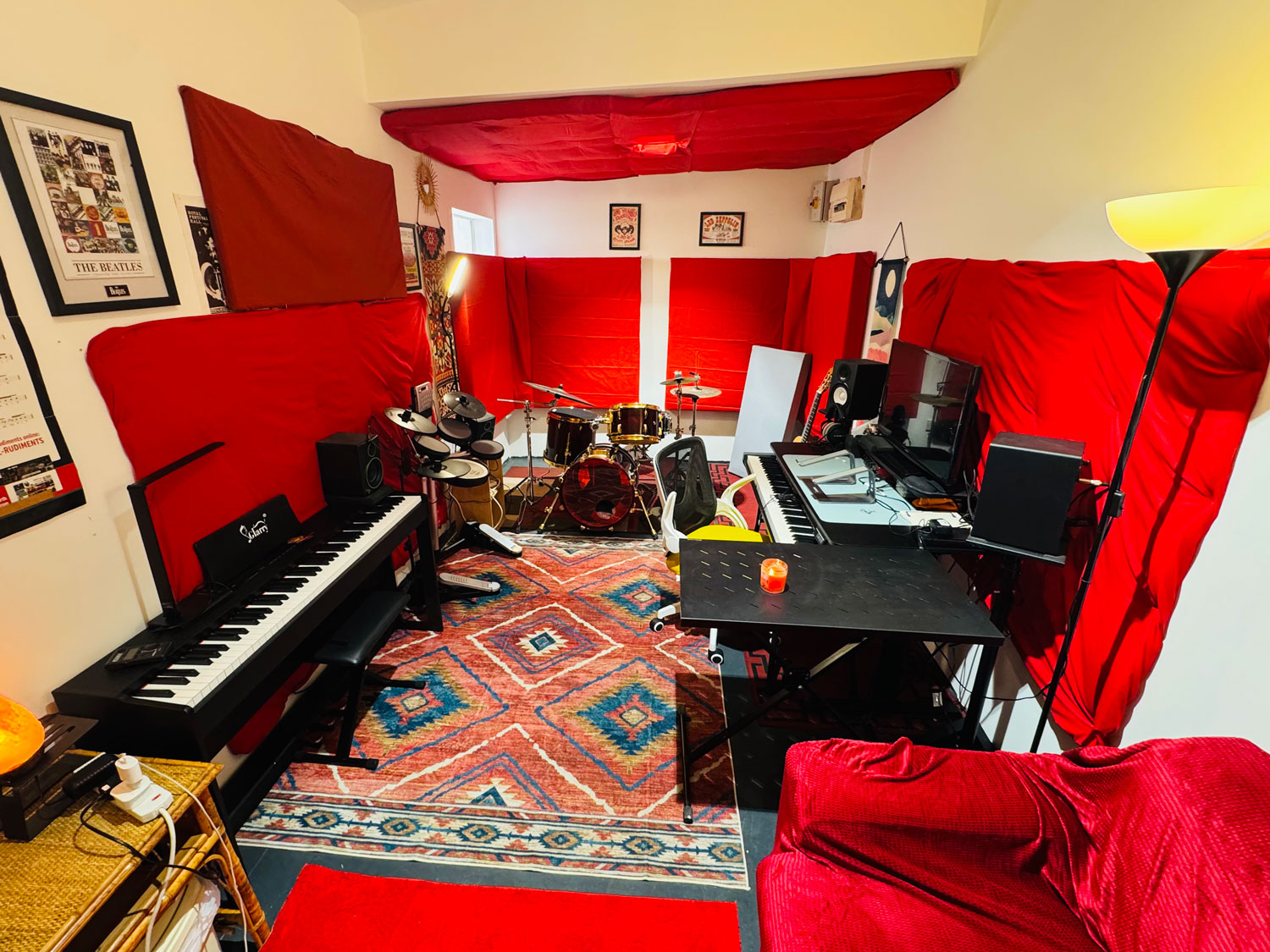 Music studio with a drum, a piano and a desk