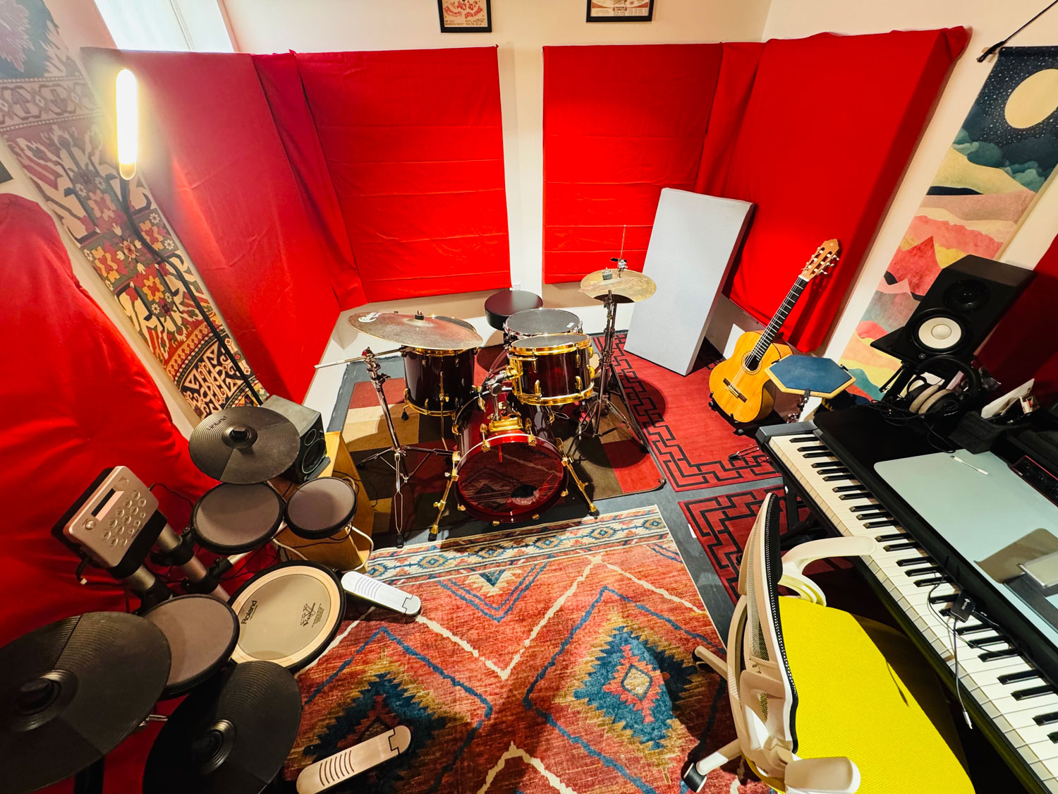 Music studio with a drum, a piano and a desk